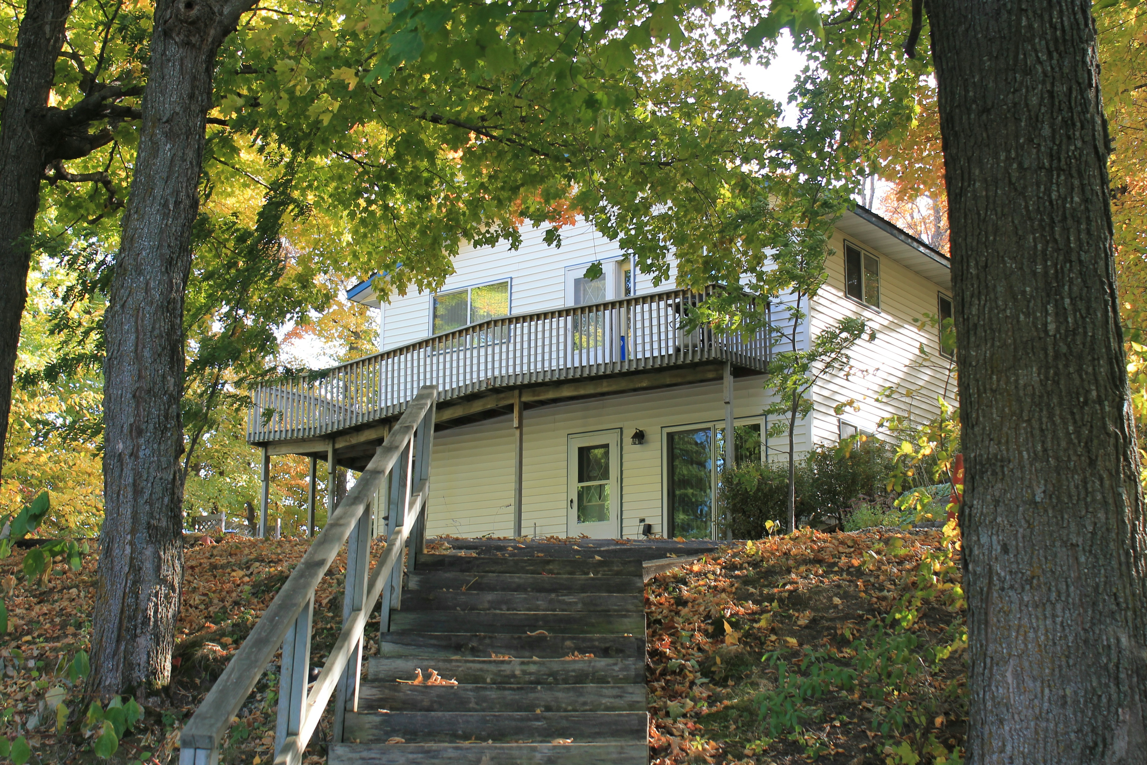 Outdoor steps with handrail leading to two-story Birchwood Overlook cabin