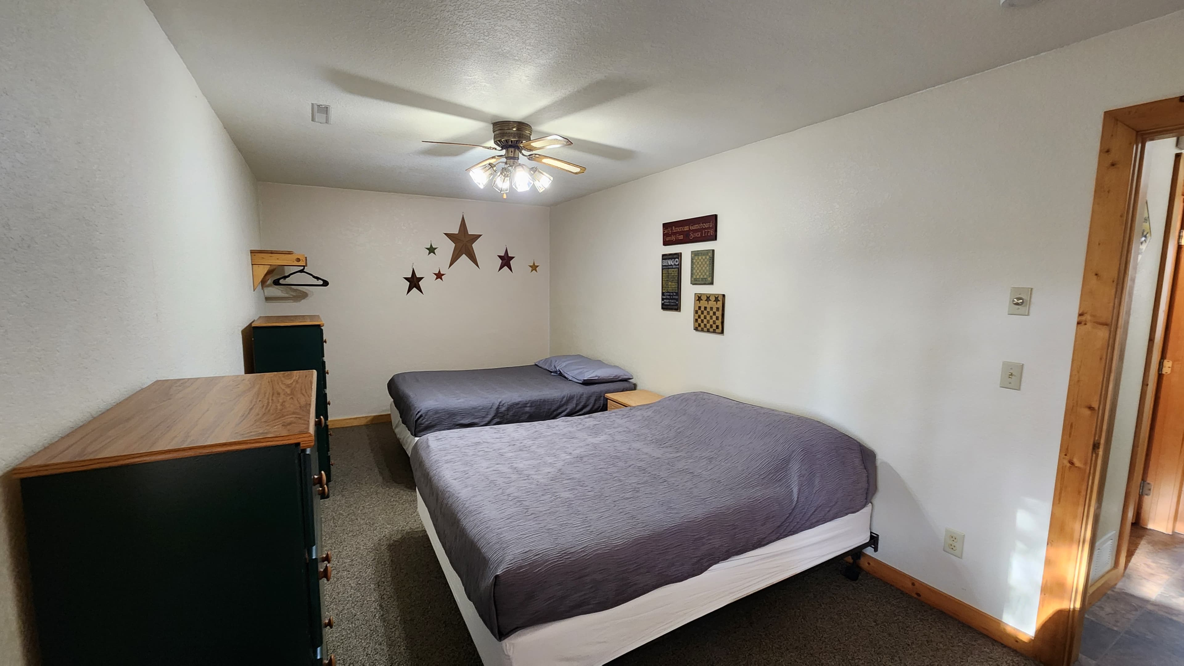 Lower-level bedroom with one queen & two full sized beds.