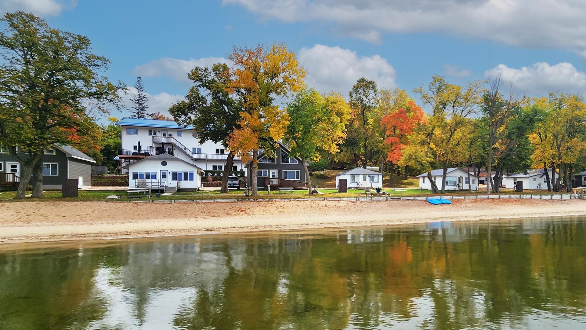 Shoreline of viking bay lodge, cabins, with trees turning fall colors