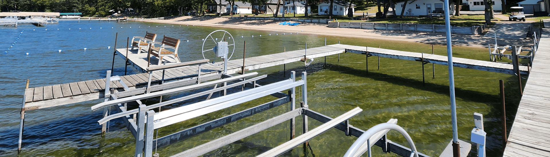 Metal doc in water, with seats built in, with shore in the background
