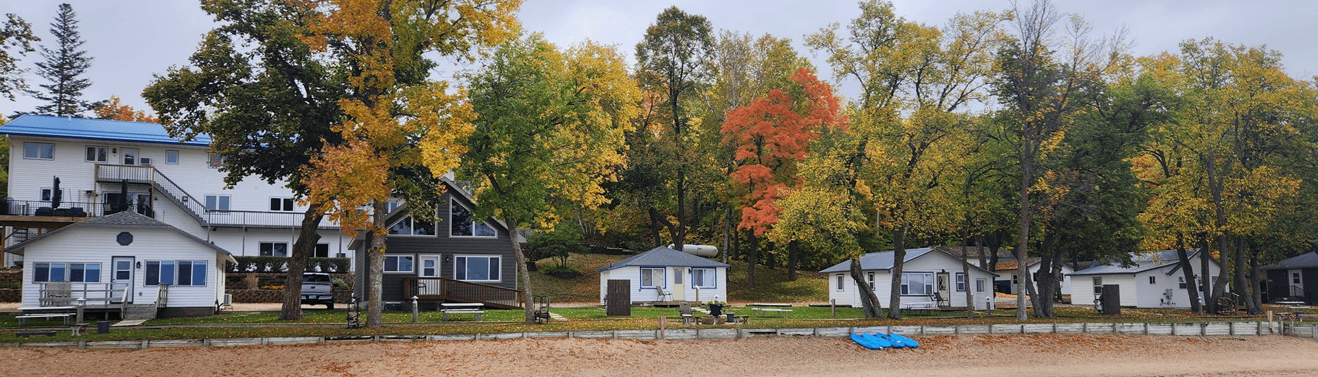 Shoreline of viking bay lodge, cabins, with trees turning fall colors